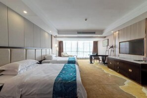 A hotel room with two beds, a desk, a television, and a large window. - Tianshun Bo'erman Hotel (Zhongshan)