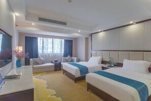 A hotel room with two beds, a desk, a chair, a TV, and a window with curtains. - Tianshun Bo'erman Hotel (Zhongshan)