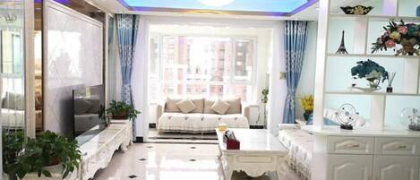A modern living room with a sofa, coffee table, and decorative items.