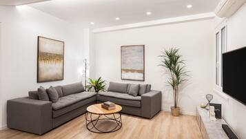 Deluxe Apartment | Living area | Smart TV, Netflix, MP3 dock, streaming services
