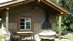 Une cabane rustique avec des fondations en pierre, une façade en briques et un toit en bois.