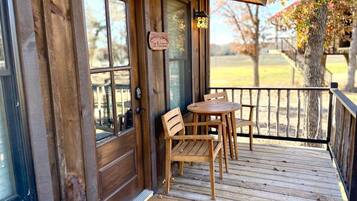 A wooden deck with a door and a sign reading 'The Nook.'