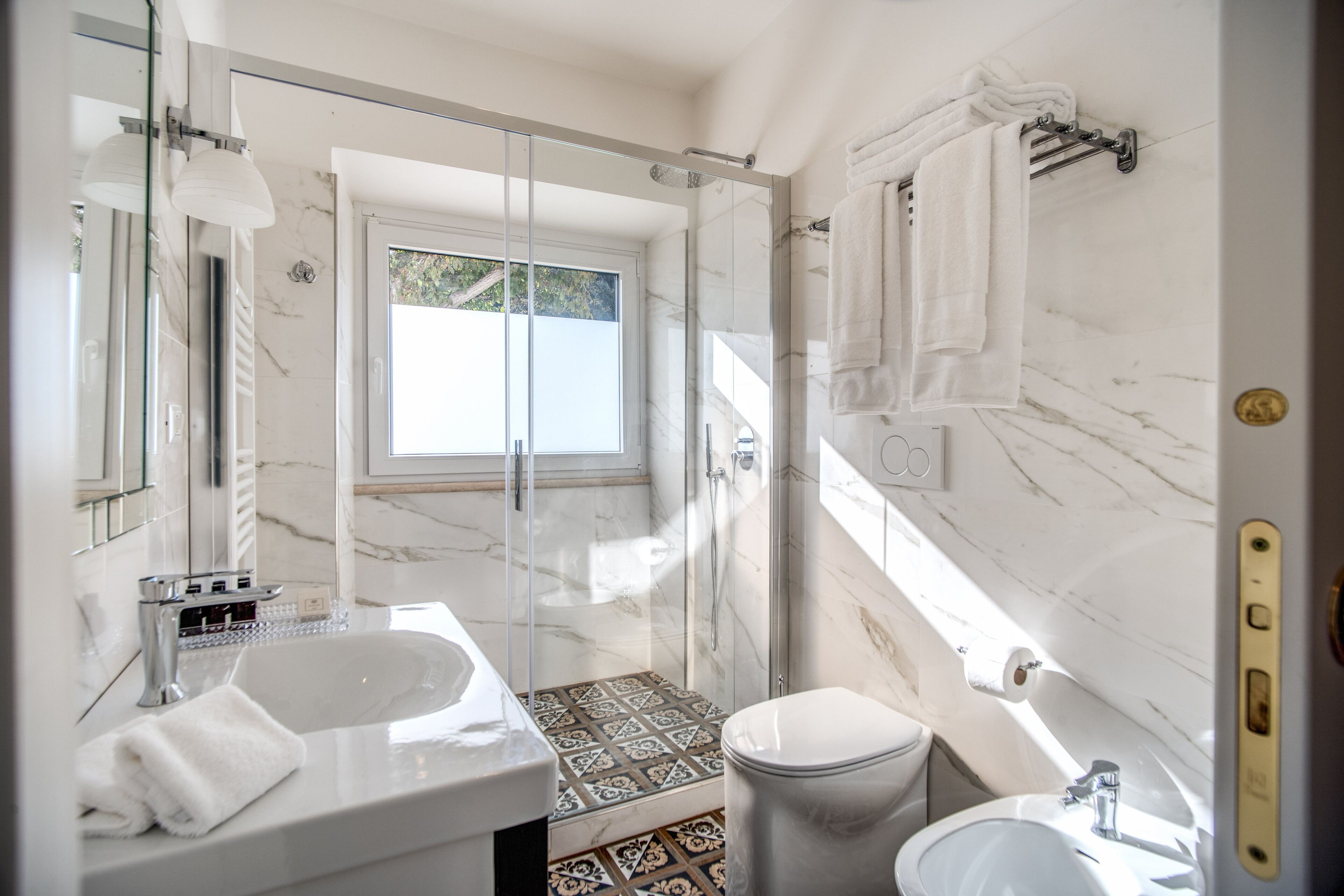 Une salle de bain moderne avec une douche à parois de verre, un grand lavabo et des toilettes.