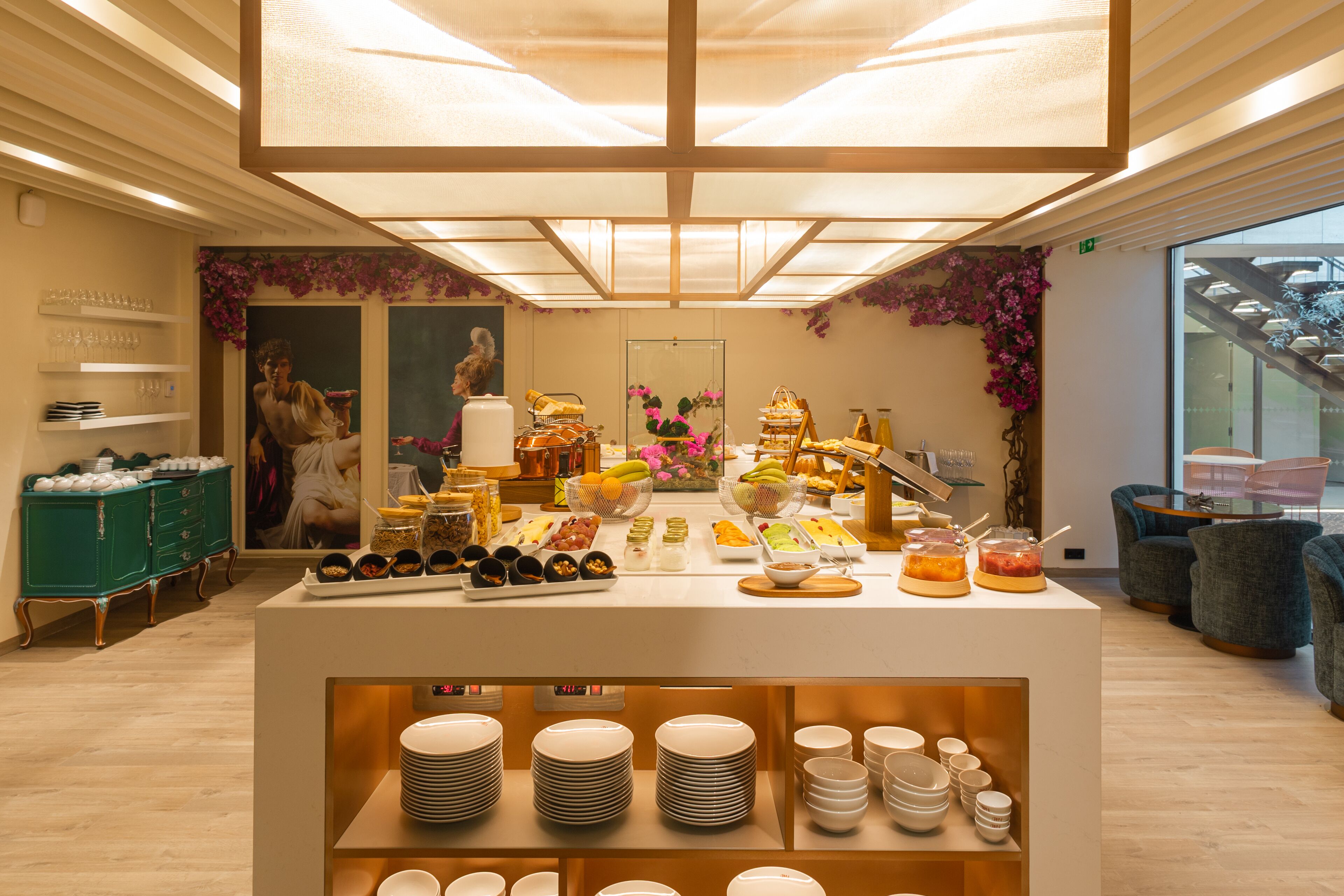 A buffet area with various food items and a display of plates.