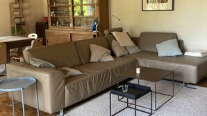 A living room with a wooden ceiling, a sofa set, a glass cabinet, and a framed picture on the wall. - Villa overlooking the countryside (La Chapelle-Saint-Sauveur)