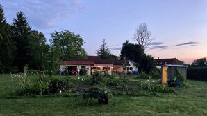A house with a red roof, a garage, and a shed in a grassy yard. - Villa overlooking the countryside (La Chapelle-Saint-Sauveur)