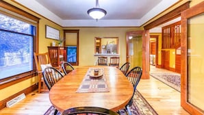 A dining room with a wooden table, chairs, and a chandelier. - The Lovemore Grand Retreat (Delta)