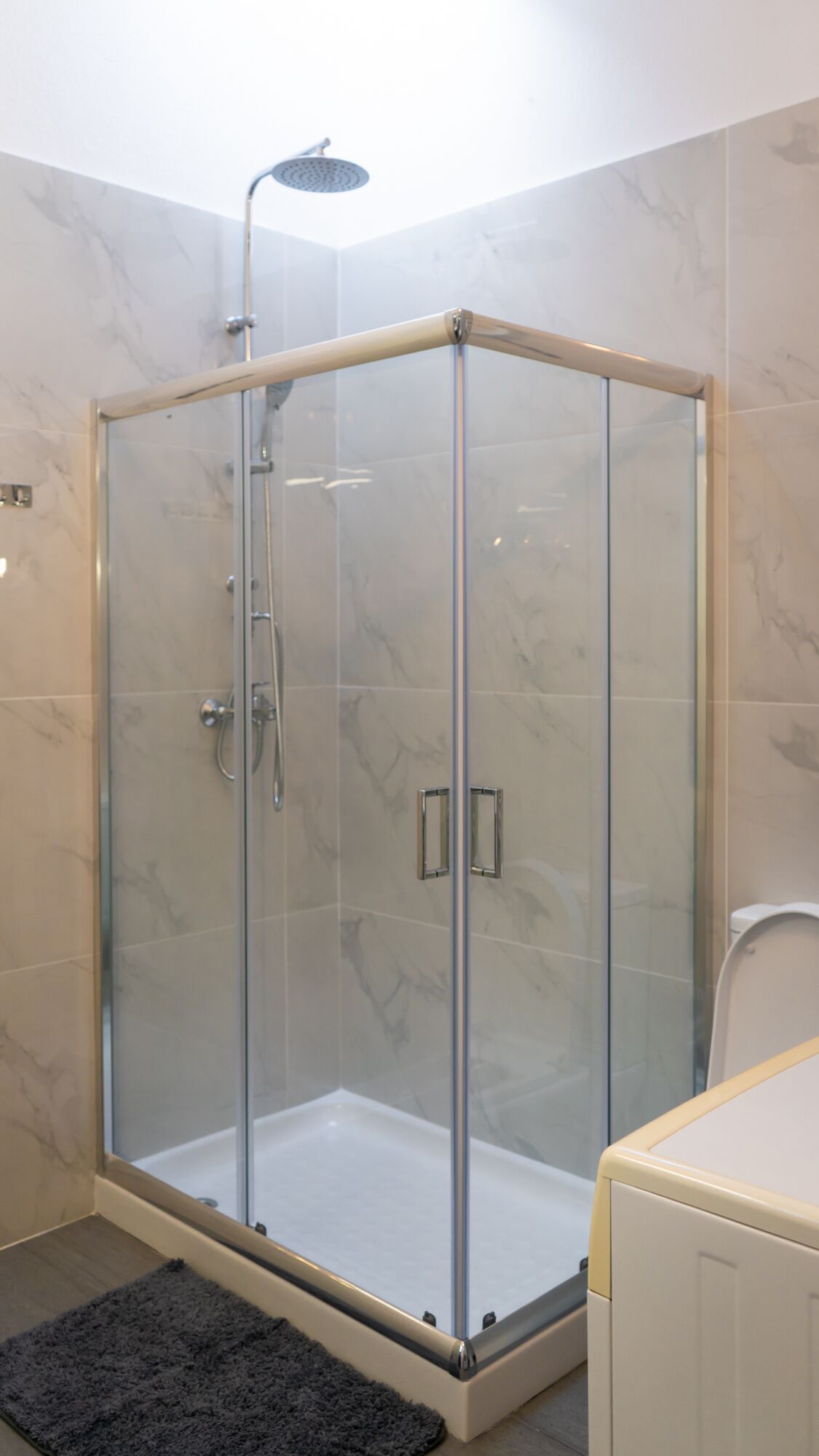 Shower, rainfall showerhead, hair dryer, towels