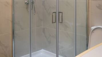 Shower, rainfall showerhead, hair dryer, towels