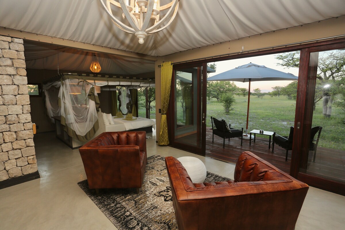 A spacious room with a large sliding glass door leading to an outdoor area with a table and chairs.