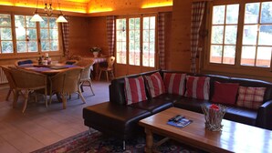 A cozy log cabin interior with a dining area, a sofa, and a coffee table. - Luxury chalet (approx. 170 sqm) in a dreamlike mountain setting - Valais (Grächen/near Zermatt) (Niedergrächen)