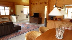 A cozy cabin interior with a living room, dining area, and kitchen. - Luxury chalet (approx. 170 sqm) in a dreamlike mountain setting - Valais (Grächen/near Zermatt) (Niedergrächen)