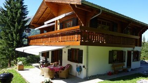 A wooden chalet with a balcony, outdoor seating, and a barbecue grill. - Luxury chalet (approx. 170 sqm) in a dreamlike mountain setting - Valais (Grächen/near Zermatt) (Niedergrächen)