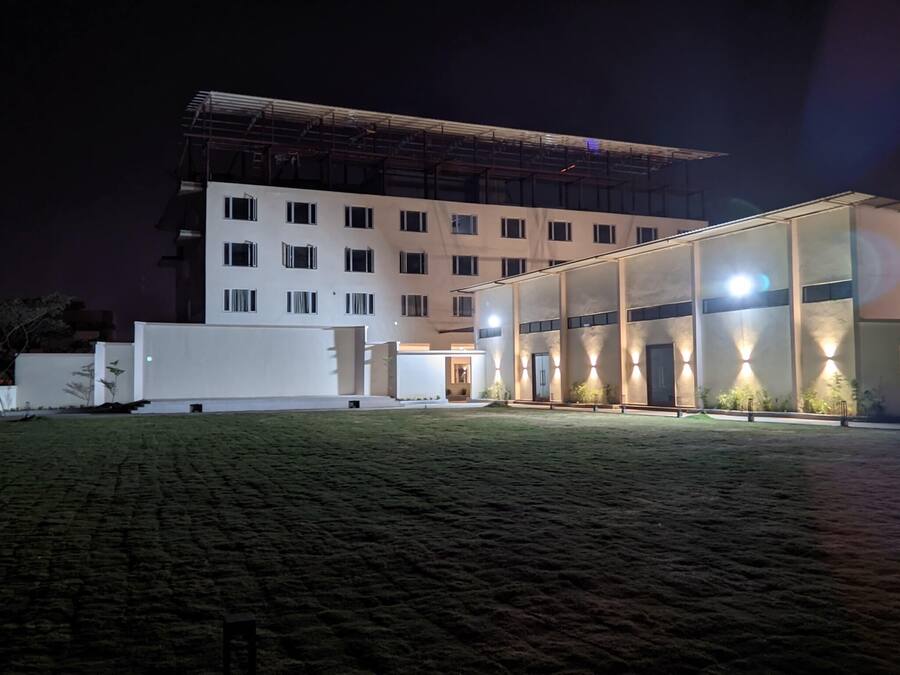 A modern building with multiple windows and a covered entrance area.