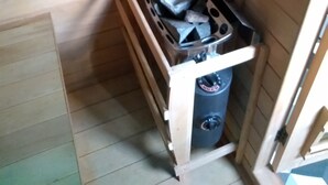 A small cabin with a wood-paneled interior, a window, a stove, and a trash can. - Baie de st valéry/somme le crotoy, cosy mobi-loft + hamman, sauna option (arrest)