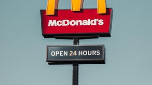Ein Schild von McDonald's mit der Aufschrift 'GEÖFFNET 24 STUNDEN' unter dem Logo.