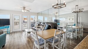 A spacious living area with a large sofa, dining table, and chairs. There are ceiling fans and pendant lights. - WATERFRONT & PET FRIENDLY (adds fees) Dockside close to ICW (Port O'Connor)