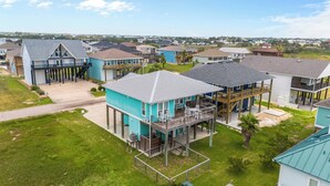 A residential area with multiple houses featuring elevated structures and porches. - PARKERSON HOUSE in Larry's Harbor POC (Port O'Connor)