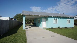 A single-story house with a light blue exterior, a white door, and a number '61' on the side. - UNCLE WOODY'S #1 in POC-Pets ok but add Fees (Port O'Connor)