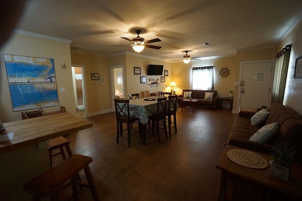 Relax in this inviting living area with a dining table, comfortable sofa, and TV.