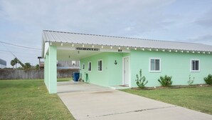 A single-story building with a light green exterior, a covered porch, and a clear sign indicating "CLEARANCE 85" and the number "89". - UNCLE WOODY'S #3 in POC-Pets ok but add Fees (Port O'Connor)