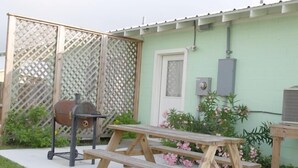 A wooden picnic table with benches in a backyard. - UNCLE WOODY'S #3 in POC-Pets ok but add Fees (Port O'Connor)