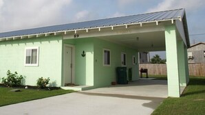 A single-story building with a covered porch, numbered 89, featuring a simple design with a flat roof and a small front yard. - UNCLE WOODY'S #4 in POC-Pets ok but add Fees (Port O'Connor)