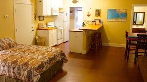 A compact bedroom with a bed, a kitchenette, and a small dining area. - UNCLE WOODY'S #4 in POC-Pets ok but add Fees (Port O'Connor)