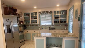 A kitchen with a built-in refrigerator, a coffee maker, and a sink. - JMJ BAY is Close to Beach in POC Charming Family Retreat (Port O'Connor)