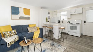 A modern apartment with a living room, kitchen, and dining area.