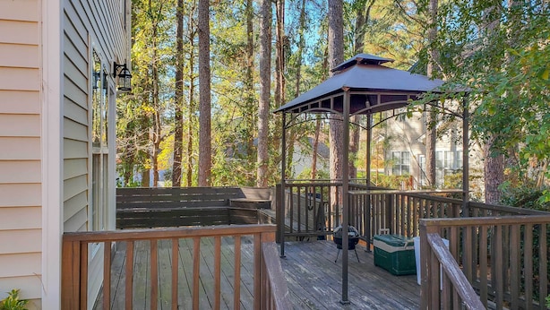 A wooden deck with a gazebo, surrounded by tall trees. - Wendell Home w/ Fenced Yard, Close to Raleigh (Wendell)