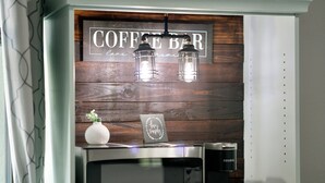 A kitchen area with a coffee bar sign, a microwave, and a coffee machine. - Spacious & Private Guest Pool House Oasis (Orlando)