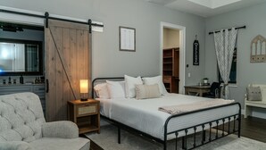 A bedroom with a bed, bedside tables, a chair, a desk, and a wardrobe. - Spacious & Private Guest Pool House Oasis (Orlando)