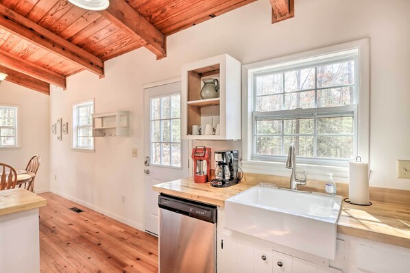 Enjoy cooking in this well-equipped kitchen with a stainless steel dishwasher, sink, and coffee maker.