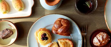 A table with various pastries and a coffee cup.