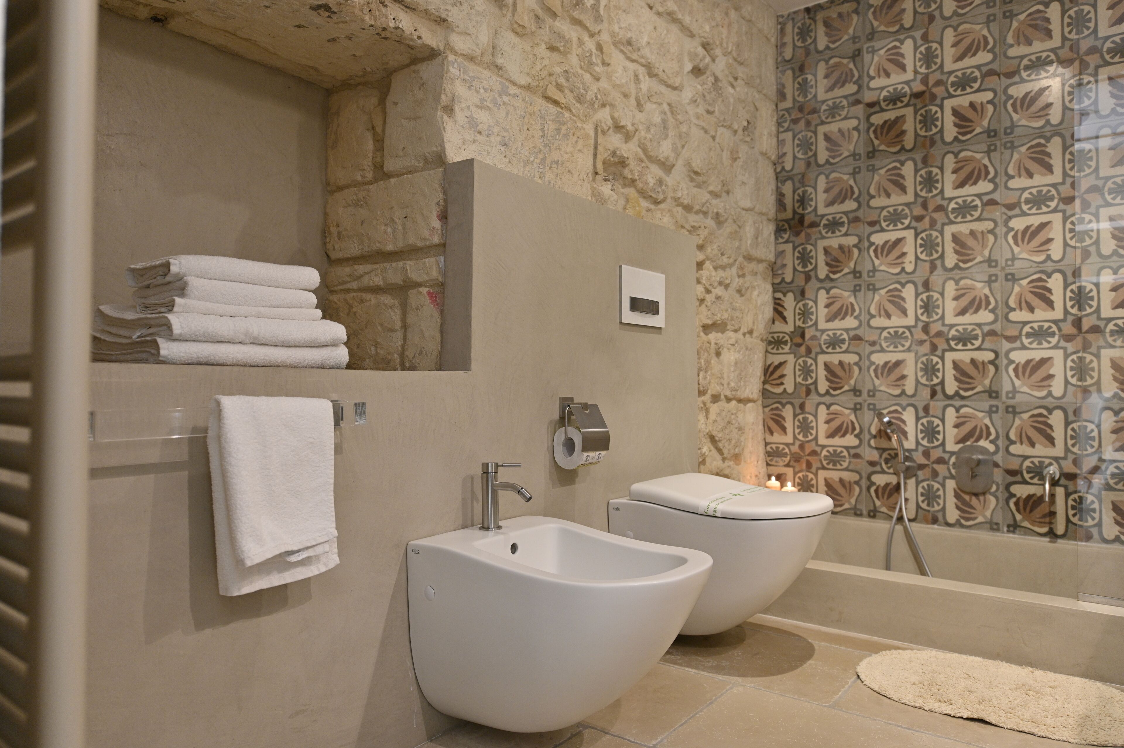 A bathroom with two sinks, a toilet, and a shower.