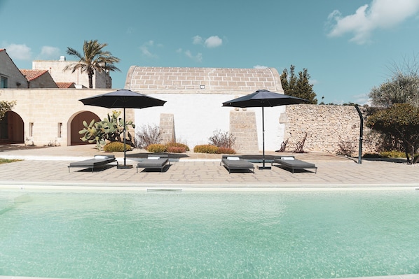 Seasonal outdoor pool, pool umbrellas, pool loungers