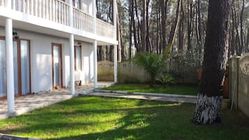 Stroll through the serene outdoor space, surrounded by lush greenery and a well-manicured lawn.