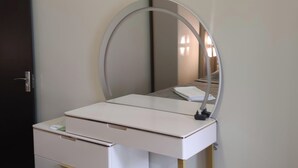 A white vanity with a round mirror and a small table. - House by the sea Kaprovani Shekvetili Batumi (Ureki)