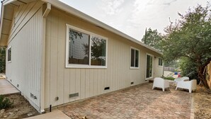 A single-story house with a patio area. - The Starlight Retreat | Clean. Bright. Modern. (Redding)