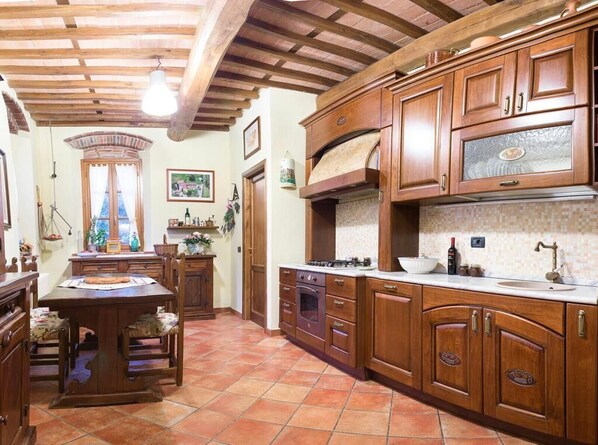 Enjoy cooking in this well-equipped kitchen with a stove, sink, and various appliances.