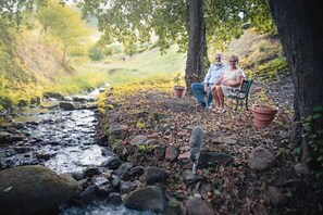 Escape to a serene natural oasis, where a tranquil stream flows gently through the landscape.