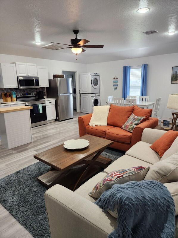 Cozy living space with a kitchenette, sofa, and coffee table.