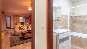 A modern bathroom with a large mirror, a sink, and a shower area. - Porto Residence Campanhã (Oporto)