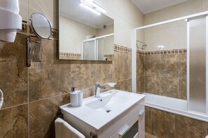 Bathtub, hair dryer, towels, soap