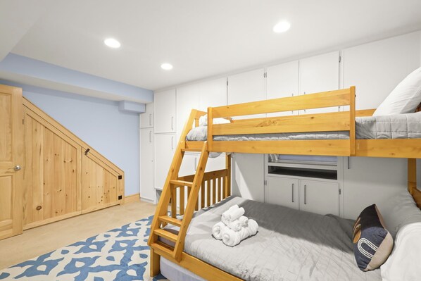 A bunk bed with a ladder, a wooden wardrobe, and a patterned rug in a bedroom. - "A Frame Haven" - West Jefferson, NC Mountain Views with Hot Tub (Laurel Springs)