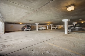 A multi-level parking garage with concrete pillars and numbered parking spaces. - Empire Coalition 2BR | Walk to Skiing | Hot Tub | Underground Parking (Park City)