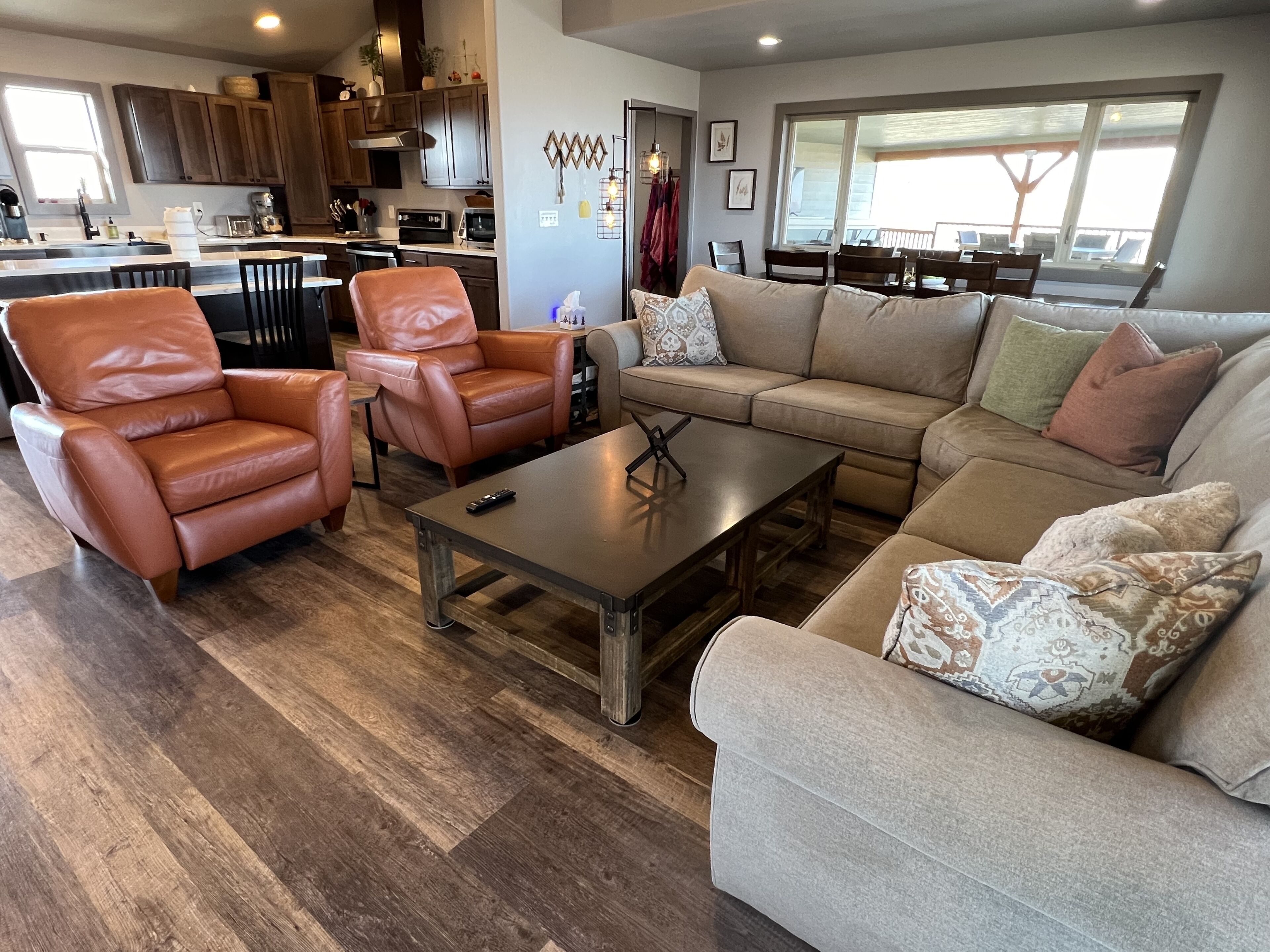 A modern living room with leather chairs, a sofa, and a coffee table.
