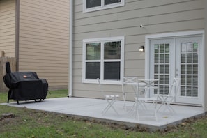 Enjoy al fresco dining on the covered patio, complete with a grill and comfortable seating.
