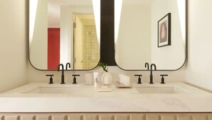 A bathroom with a large mirror, two sinks, and a white countertop. - Beautiful Hotel 2 mins from the strip-The Virgin Hotel- (Las Vegas)